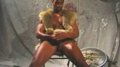 Black Gladiator Stud Sits On His Chair And Chokes The Life Out Of His Prick