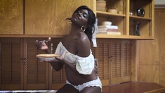 Sexy ebony teen cooking and stripping